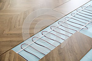 Installation of modern underfloor trace heating system indoors