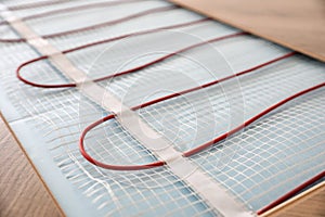 Installation of modern underfloor trace heating system indoors, closeup