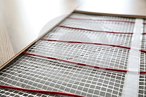 Installation of modern underfloor trace heating system indoors, closeup