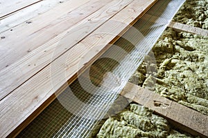 Installation of new floor of wooden natural planks and mineral wool insulation for isolation and keeping warmth. Modern technologi