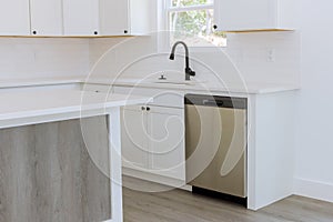 With the installation of new kitchen cabinets in a kitchen, you can view a water tap sink