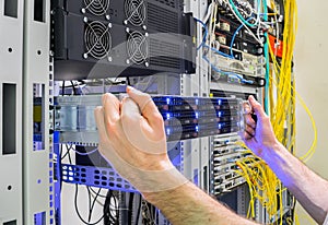 Installation of a new server in a rack with computer equipment. Performing work to replace the server in the data center. The