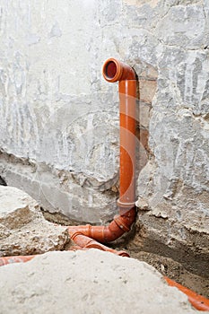 Installation of a new sewer pipe in the bathroom during main home renovation. Vertical shot