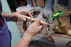 Installation of an outdoor faucet.  Plumber during the preparation work to install an outdoor faucet.