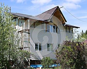 Installation of panels beige siding on the facade