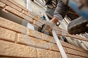 Installation of plastic siding under the brick