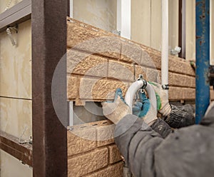 Installation of plastic siding under the brick