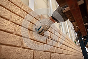 Installation of plastic siding under the brick