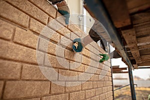 Installation of plastic siding under the brick