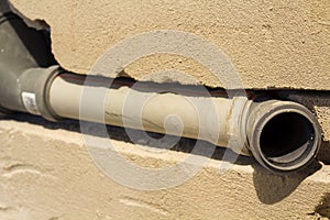 Installation of sewer pipes in a bathroom of an apartment interior during renovation works. Gray plastic drain pipe for used water