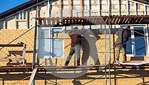 Installation of siding on the walls of the house