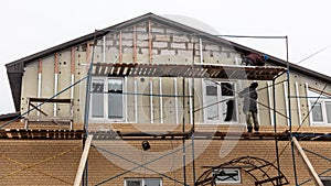 Installation of siding on the walls of the house