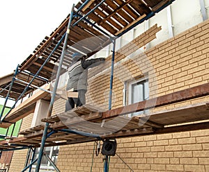 Installation of siding on the walls of the house