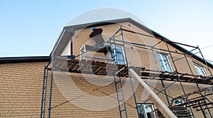 Installation of siding on the walls of the house