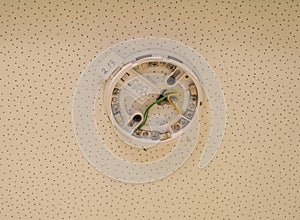 Installation of smoke on the ceiling. smoke detector in disassembled form. lower base. home security