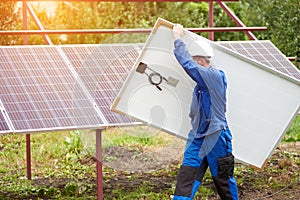 Installation of stand-alone exterior photo voltaic panels system. Renewable green energy generation.