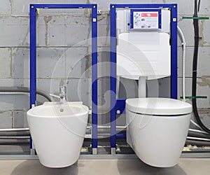 Installation systems for toilets and bidets