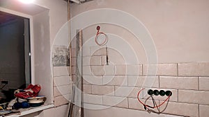 Installation of tiles in the kitchen, construction work in the corner of the room