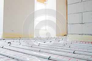 Installation of underfloor heating pipes for water heating. Heating systems. Pipes for underfloor heating.