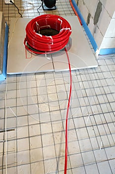 Installation of underfloor heating system, closeup on the water floor of the interior heating system of a new apartment building