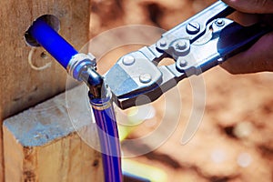 During installation of water piping system, plumber connects a blue PVC pipe