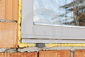 Installation of a window in a brick building. Industrial engineering. Darkening and installation of a window opening using