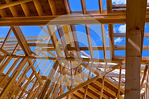 Installation of wooden beams at construction the assembled ceiling and wall on house