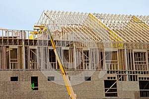 Installation of wooden beams at construction of the frame house material