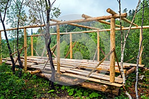 Installation of wooden beams from logs