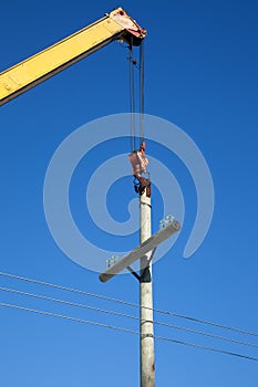 Installation of wooden electric poles crane