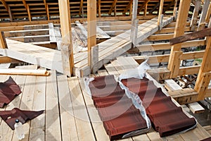 Installation of a wooden roof. Packaging of Onduvilla Bituminous tiles, lying on a construction site.Woods elements and components