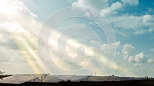 Installed row of photovoltaic solar power plant under clear cloudy sky in sunny day