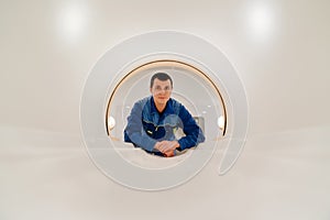 installer engineer of mri apparatus in scanner. blue uniform