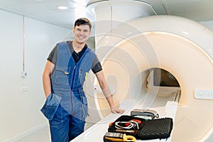 installer engineer of mri apparatus with tools near scanner