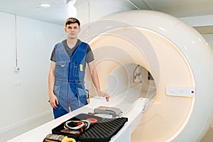 installer engineer of mri apparatus with tools near scanner