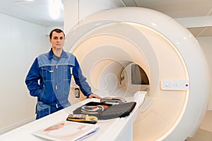 installer engineer of mri apparatus with tools near scanner