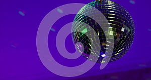 The installer of maintenance service spins disco ball with hand, checking the serviceability of the work of