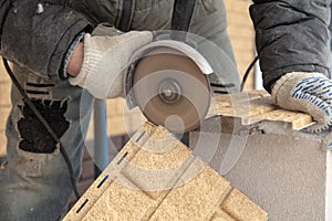 Installing brick siding on the wall of the house