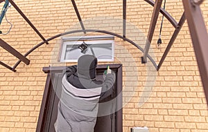 Installing brick siding on the wall of the house