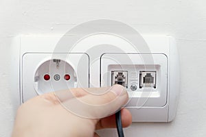 Installing a cable socket on the telephone line in the wall