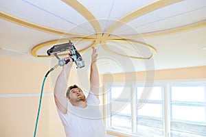 Installing ceiling moldings in the interior handyman using gauge finish nailer