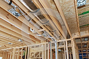 Installing a central HVAC system puts spotlight on wooden beamed ceiling in new home.