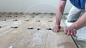 Installing ceramic floor tiles. Professional builder worker installing on floor a ceramic tile at repair renovation work 4