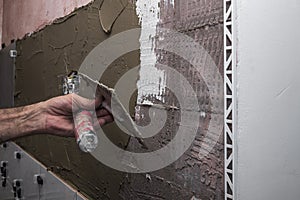 Installing ceramic wall tiles with tile levelers