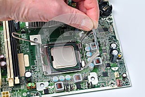 Installing a computer processor into the motherboard socket, close-up view