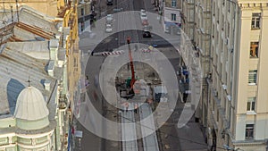 Installing concrete plates by crane at road construction site timelapse.