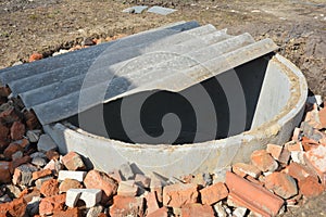 Installing concrete septic tank photo. Sewer tank hole installation outdoors