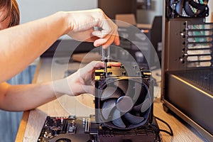 Installing a cooler on a personal computer processor.