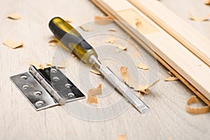 Installing the door hinge on the door frame with a hand tool at home