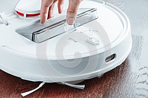 Installing a dust collection container in a vacuum cleaner robot close-up